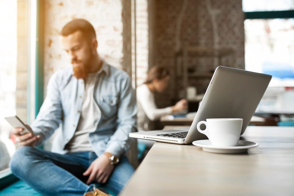 Businessman using smartphone in cafe